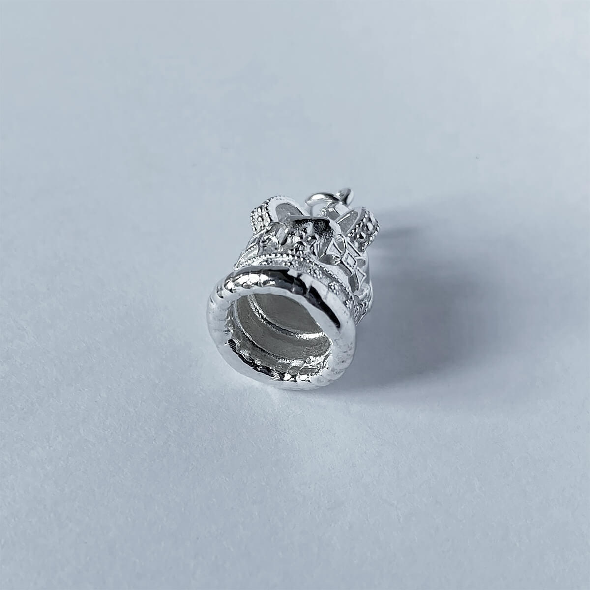 Sterling silver St Edward's crown charm on a pale grey background