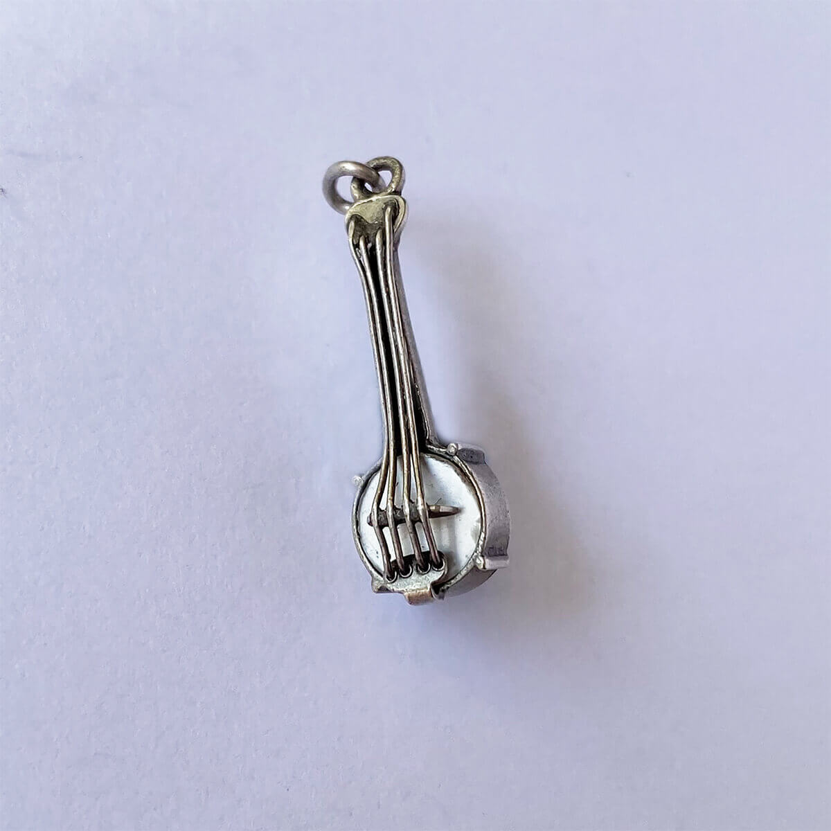 Vintage silver banjo guitar on grey background