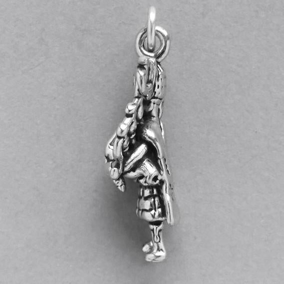 bagpiper charm in silver on grey background