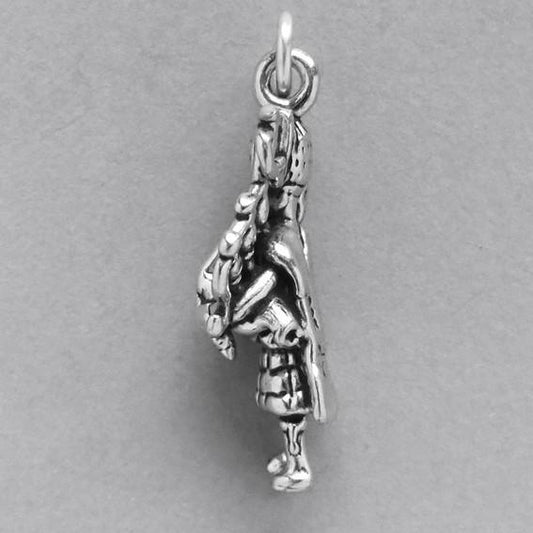 bagpiper charm in silver on grey background