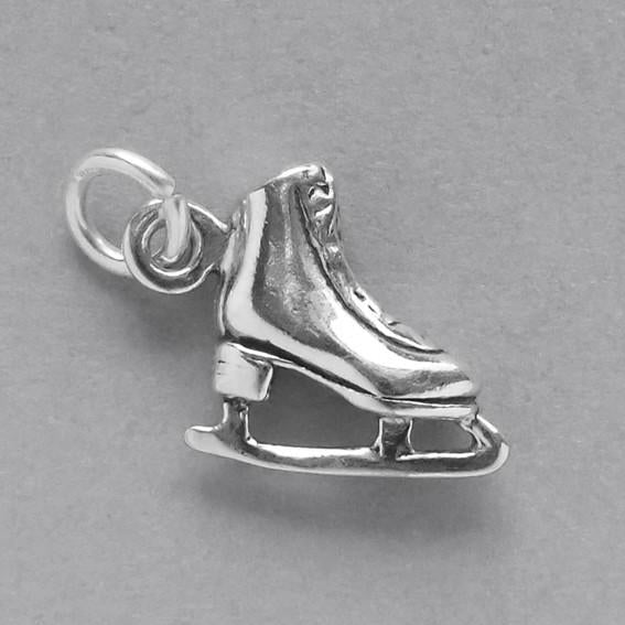 miniature Ice skate charm .925 sterling silver on grey background
