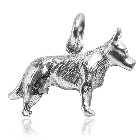 Silver cattle dog charm seen from side on a white background.