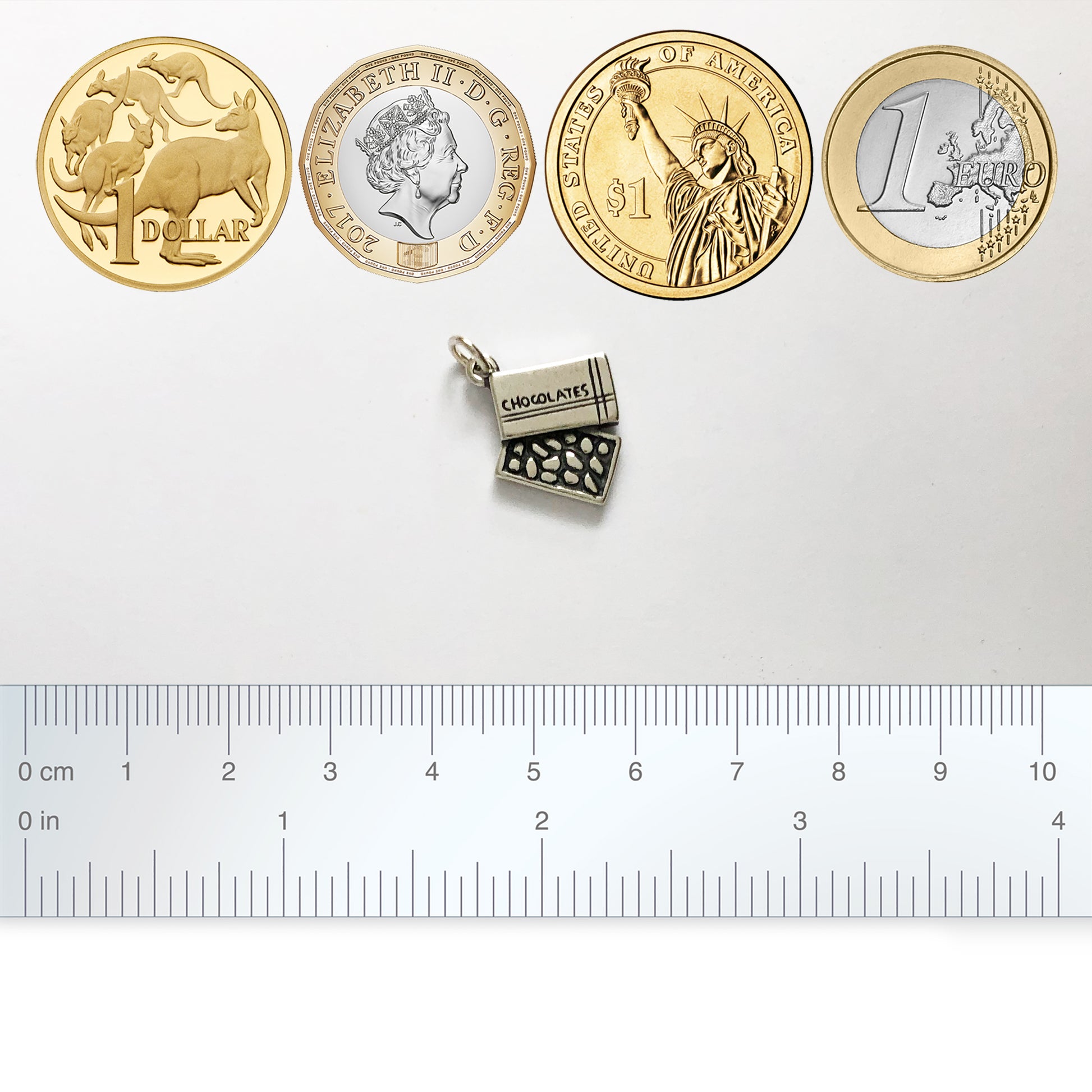silver box of chocolates charm with coins and ruler for scale