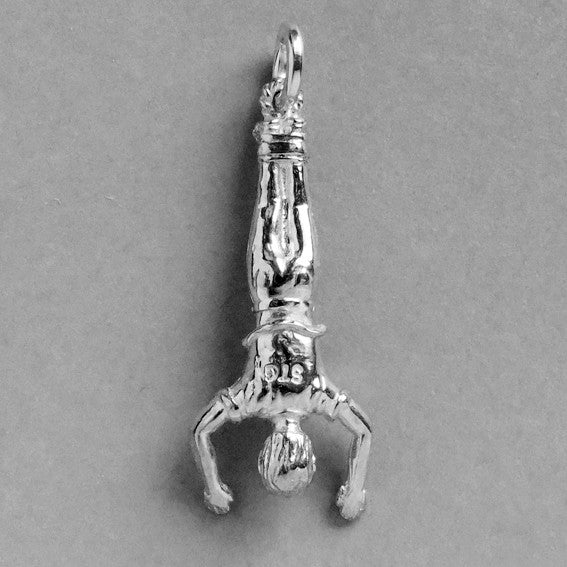 a silver bungee jumper charm on a grey background