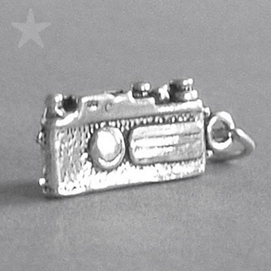 silver traditional camera charm on a grey background