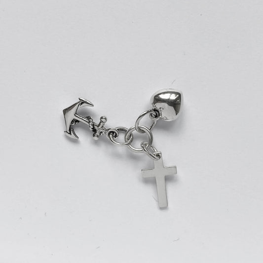 silver faith hope charity charm on light grey background