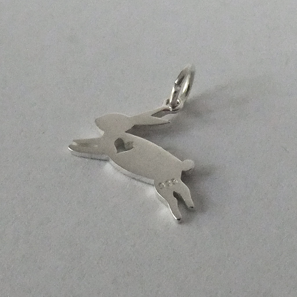 silver rabbit charm silhouette with heart on grey background