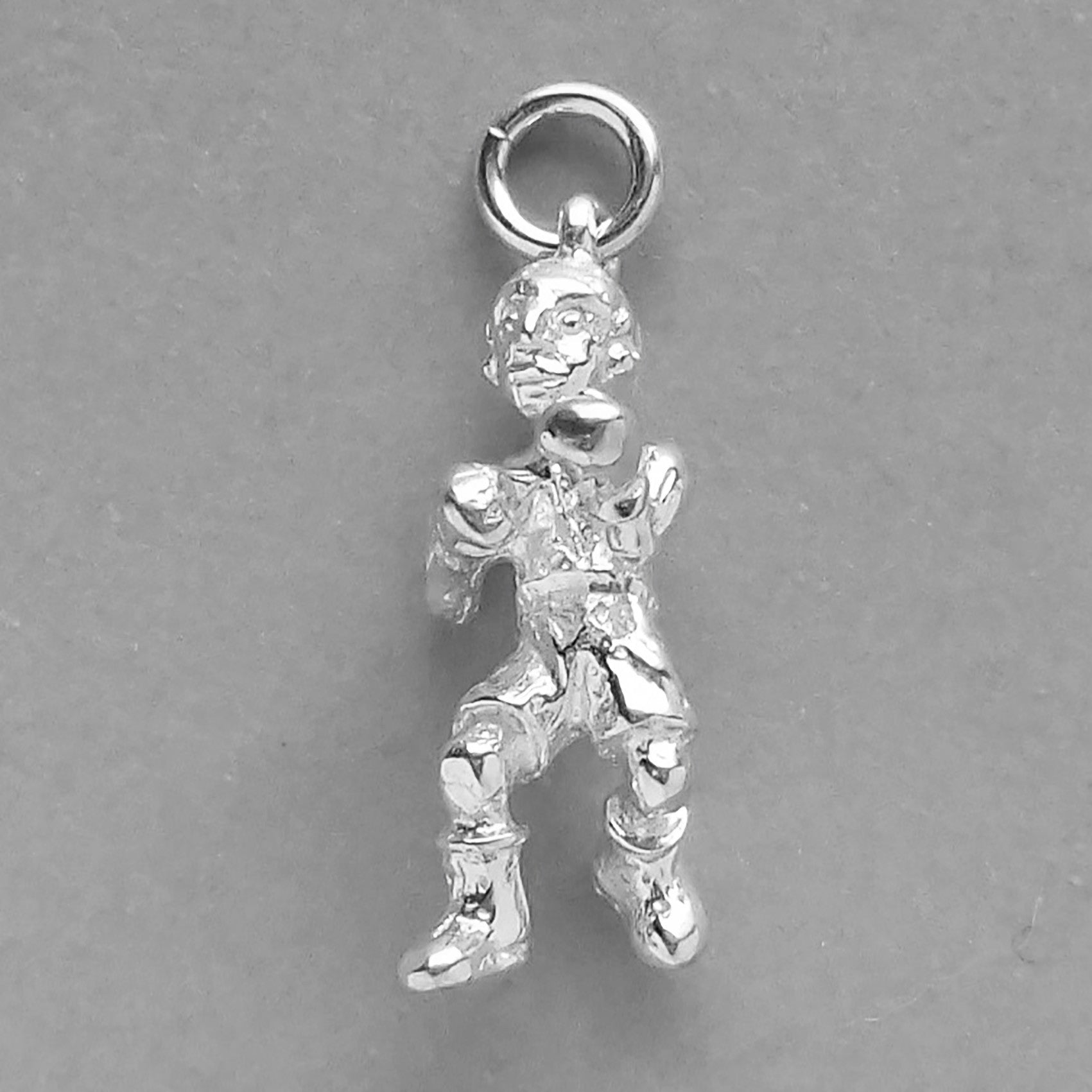 A sports boxer charm in silver on a grey background