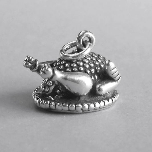 silver cooked chicken charm on grey background