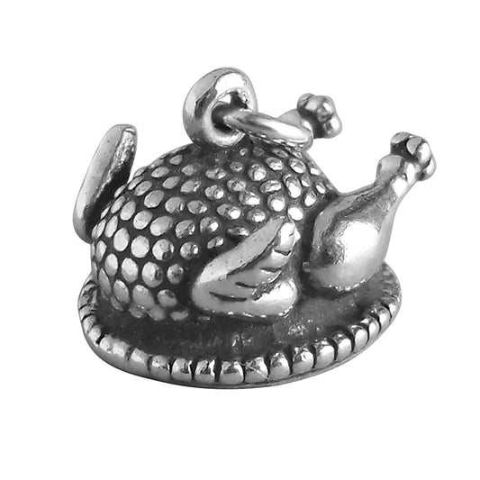silver cooked turkey charm on white background