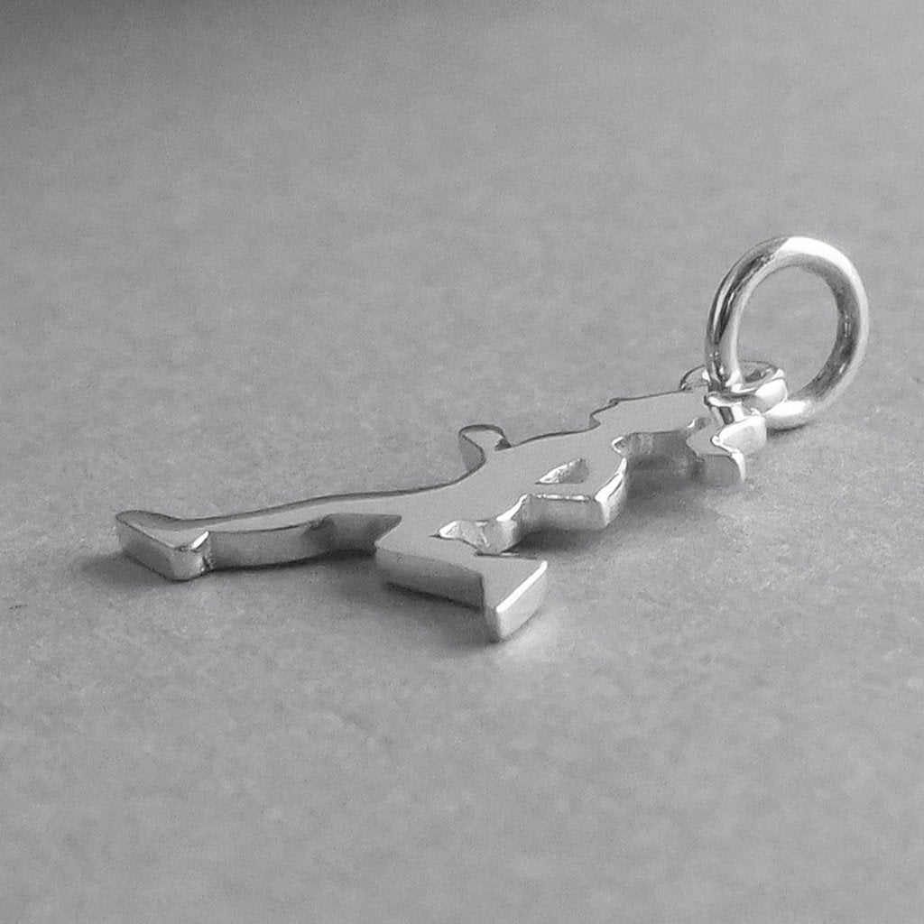 silver running girl charm on grey background