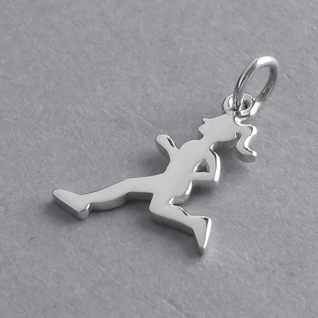 silver running girl charm on grey background