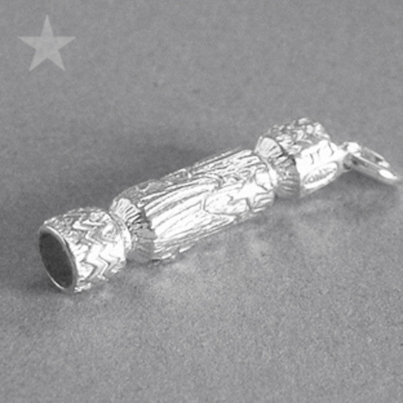 silver Christmas cracker charm on grey background