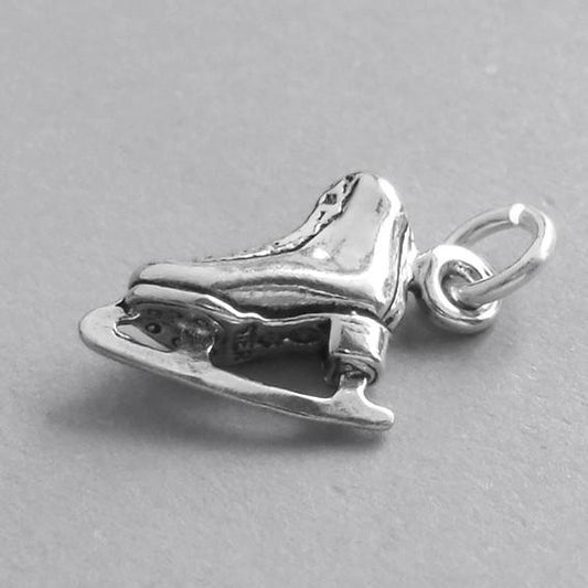Very small Ice skate charm .925 sterling silver on grey background
