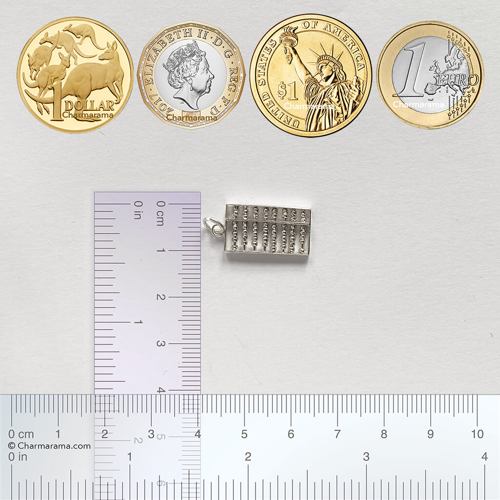 Silver abacus charm with ruler and coins for scale