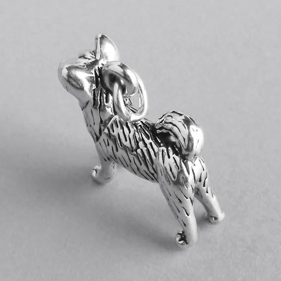 top view of akita dog charm on grey background