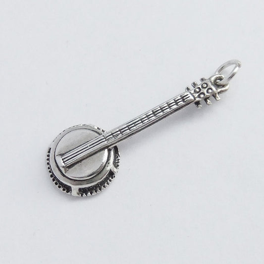 sterling silver banjo guitar pendant on light grey background