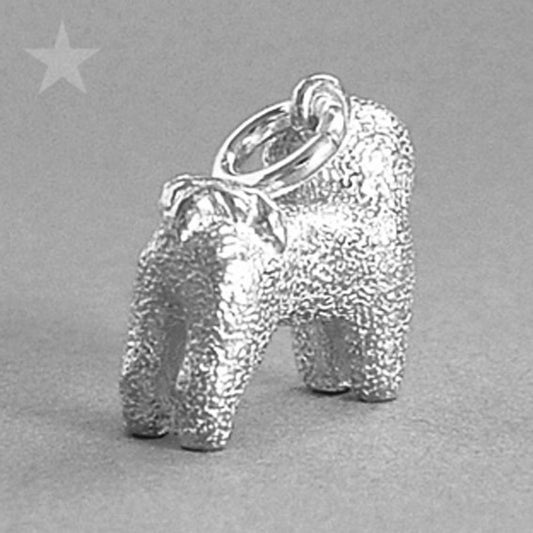 silver bichon frise dog charm on grey background