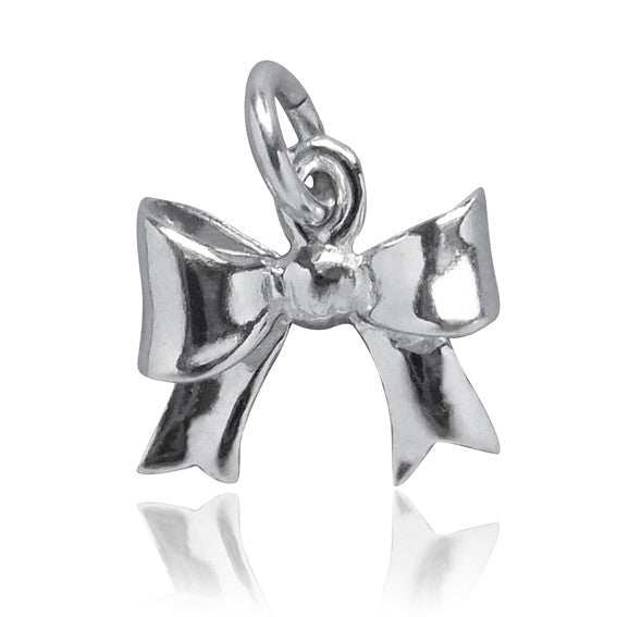 miniature silver bow charm on white background