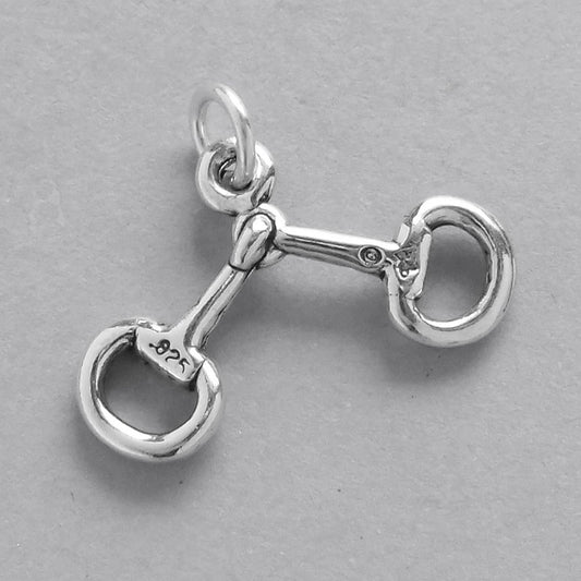 silver horse riding bridle bit charm on a grey background