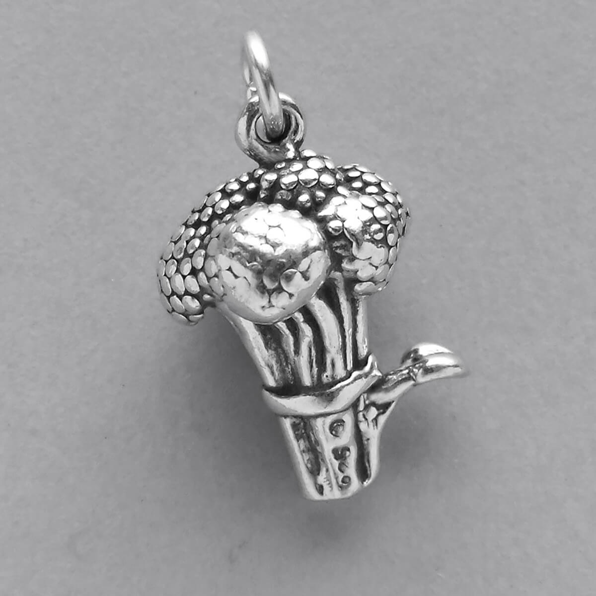 Sterling silver broccoli charm on grey background