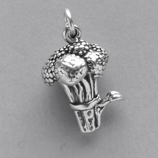 Sterling silver broccoli charm on grey background