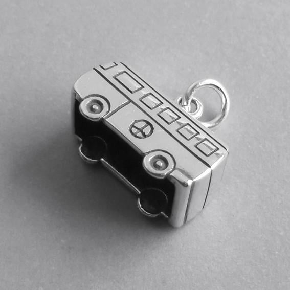 silver camper van charm on grey background
