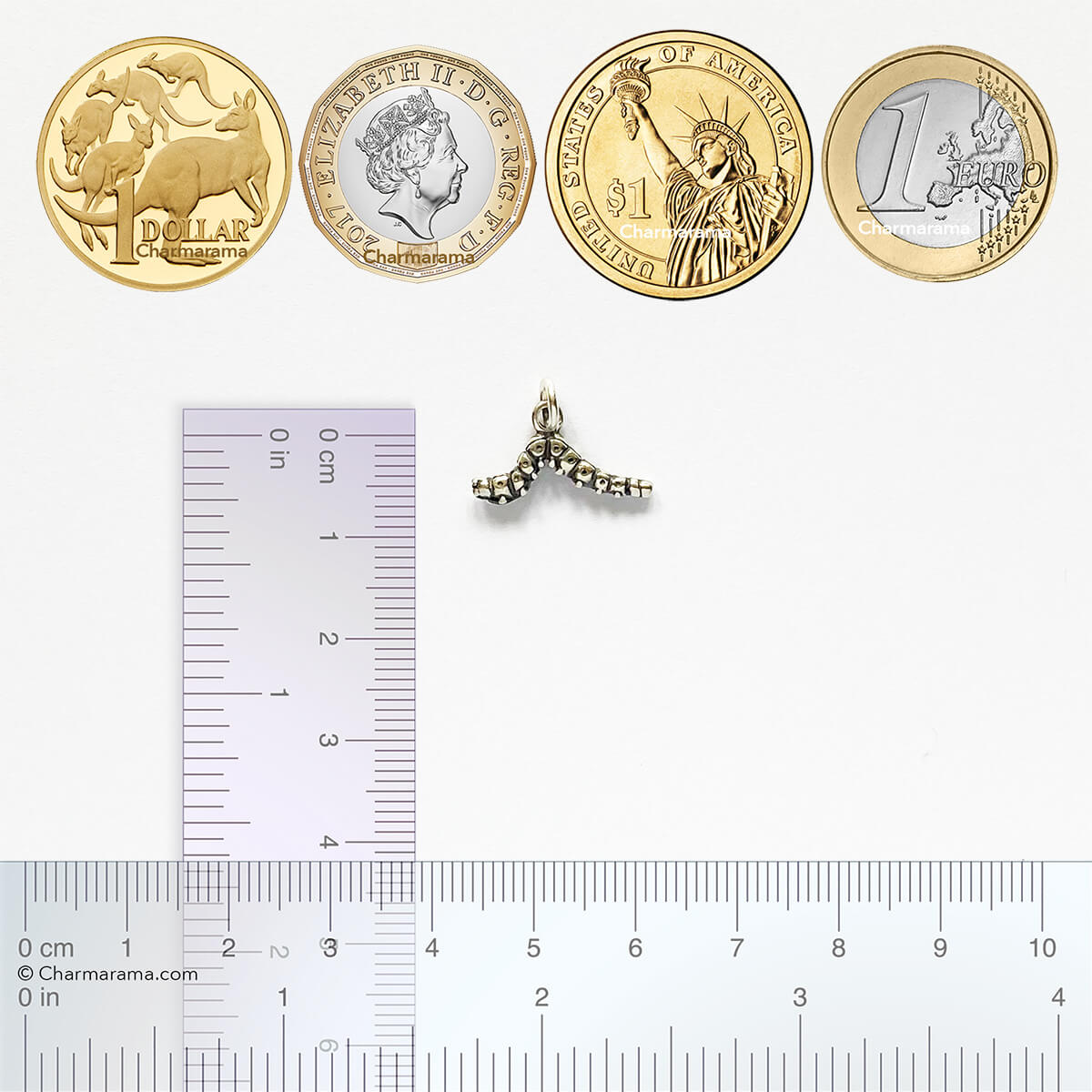 silver caterpillar charm with coins and ruler for scale
