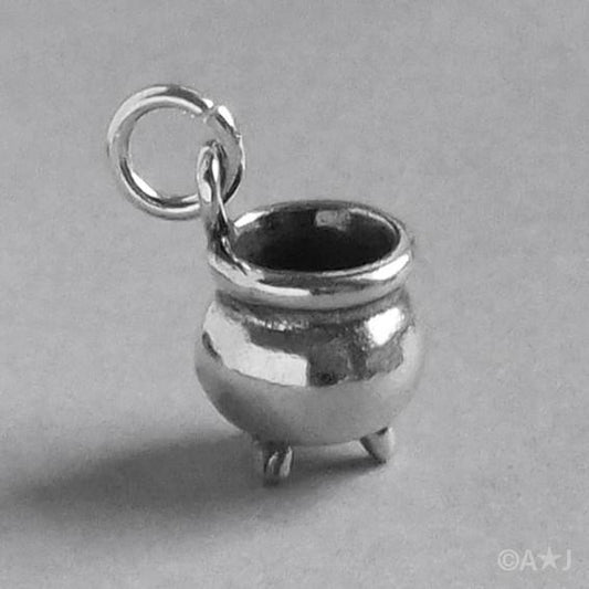 silver witch's cauldron charm on grey background