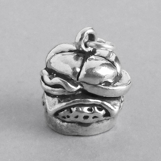 silver cheeseburger charm on a grey background