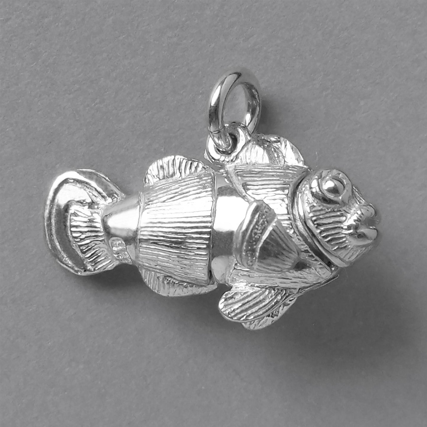 Sterling silver clownfish charm on grey background