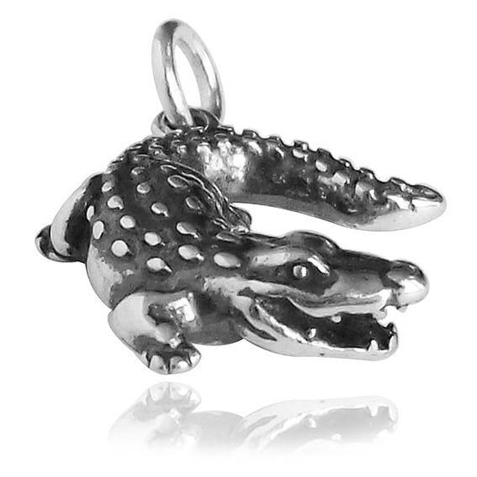 Silver crocodile charm on a white background