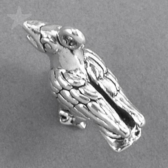 silver crow charm on grey background
