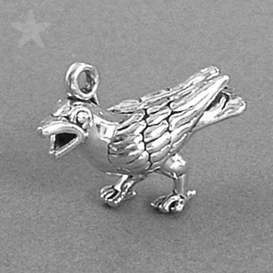 silver crow charm on a grey background