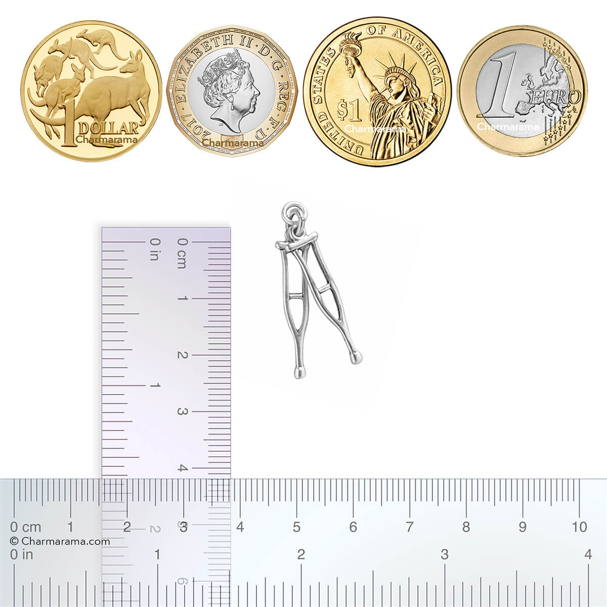 Sterling silver crutches charm with coins and ruler for scale on a white background