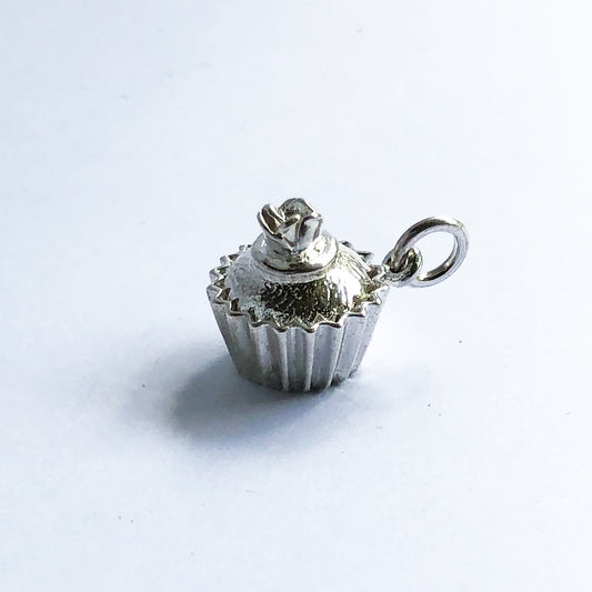 Sterling silver cupcake charm with rose decoration on a white background