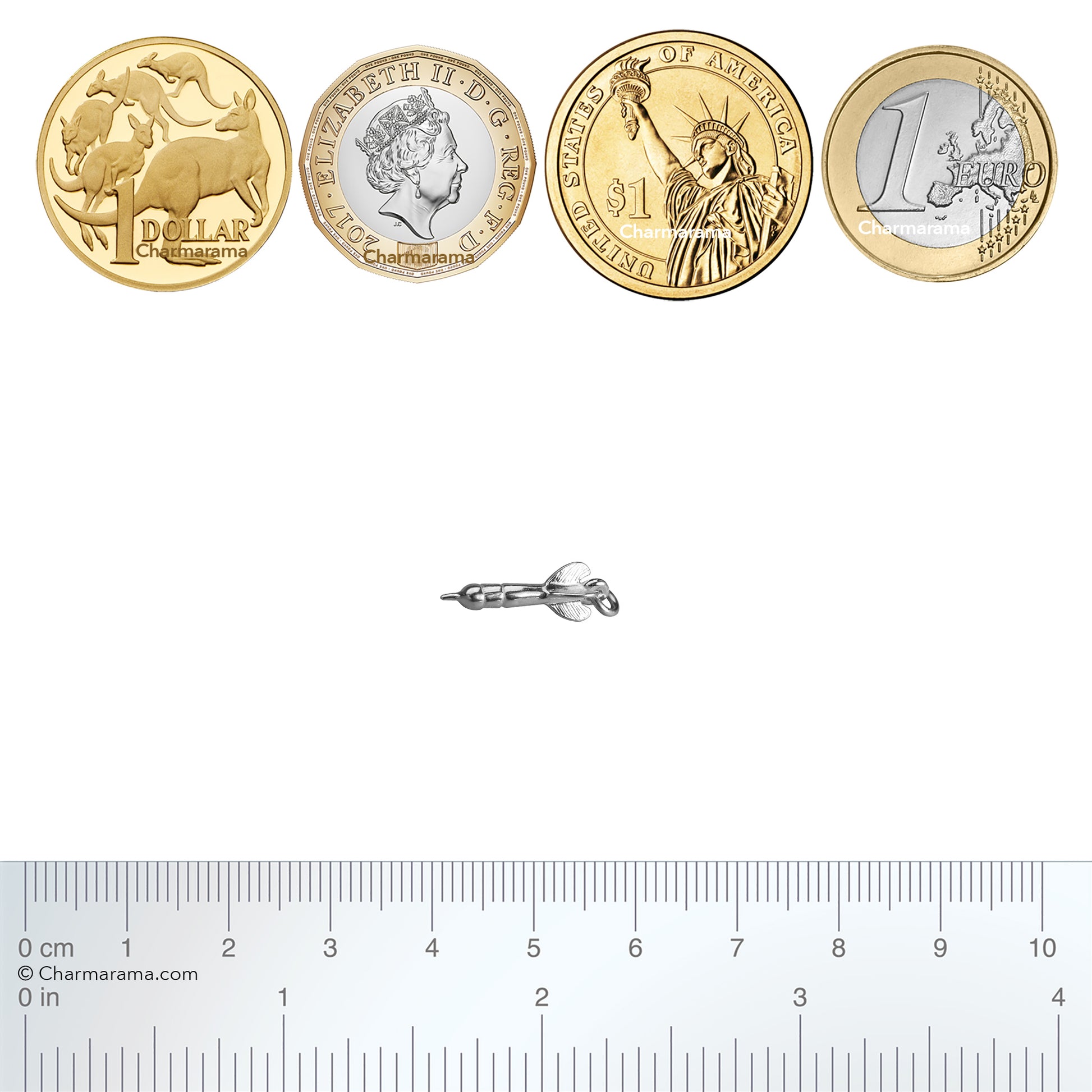 Sterling silver dart charm with coins and ruler for scale on a white background