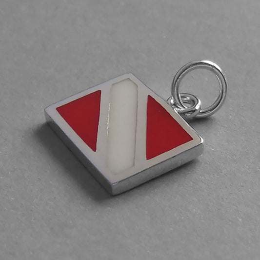 Sterling silver and enamel diving flag charm on a grey background