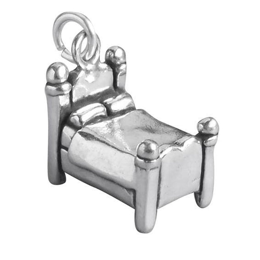 silver bed charm on white background
