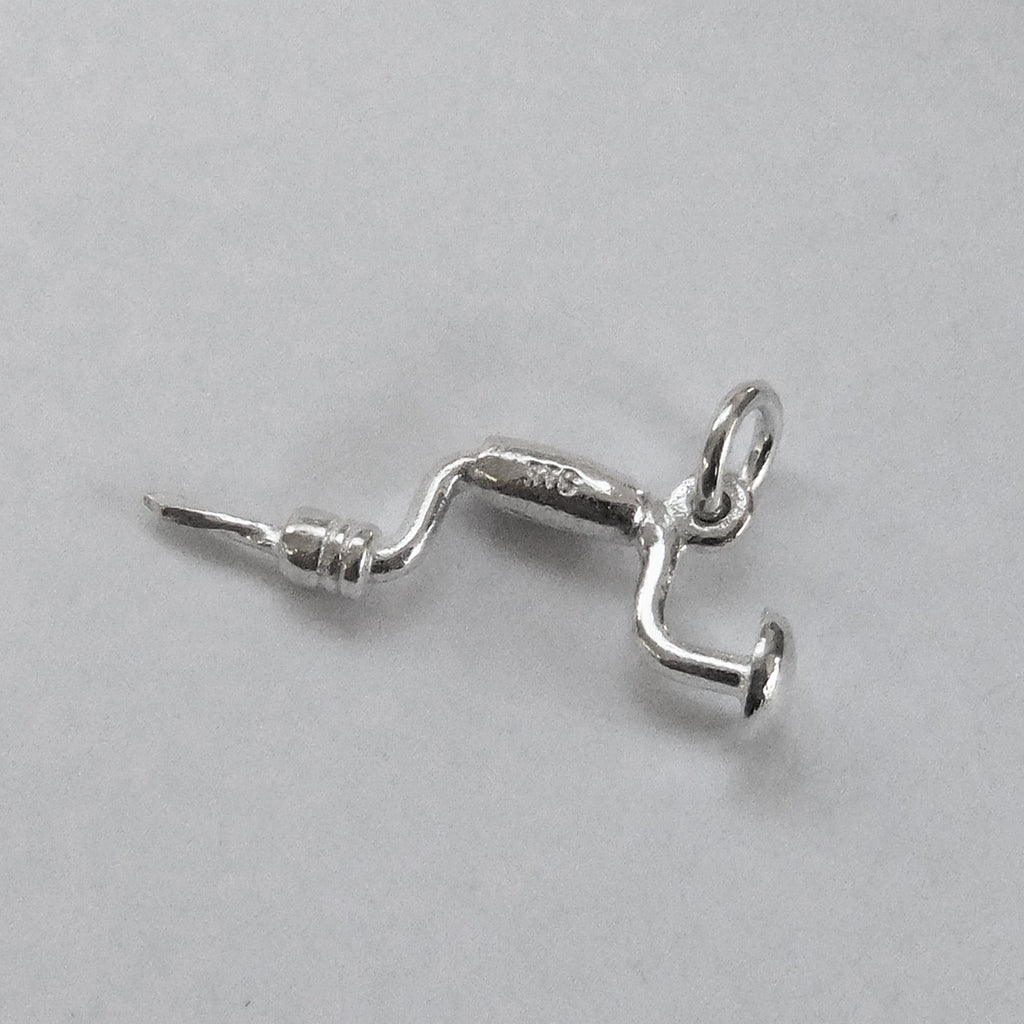 silver brace charm on a grey background
