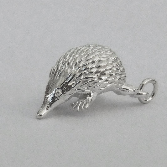 Sterling silver Australian echidna charm on a grey background