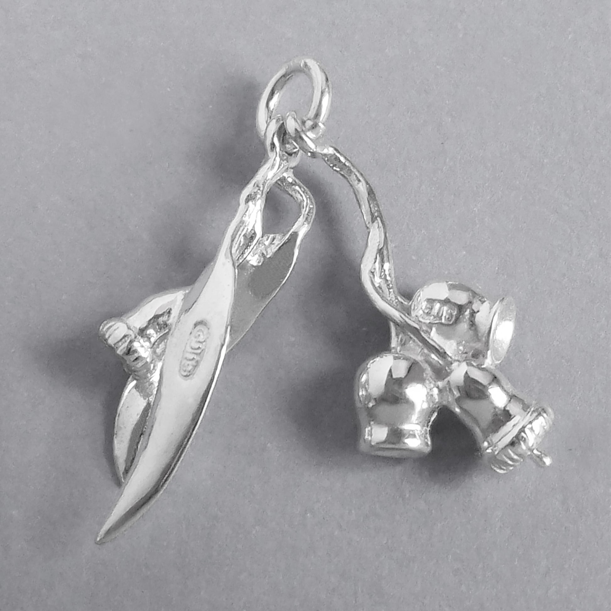 Sterling silver eucalyptus charm on a grey background