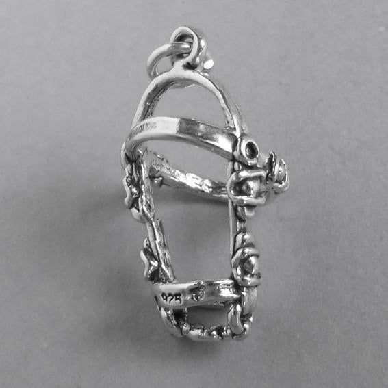sterling silver horse bridle charm on a grey background