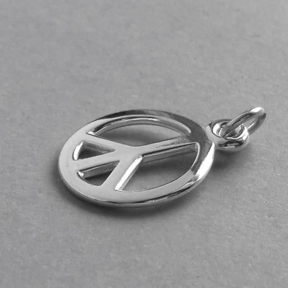 silver peace sign charm on grey background