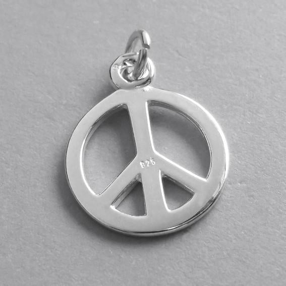 Back of silver peace symbol charm on grey background