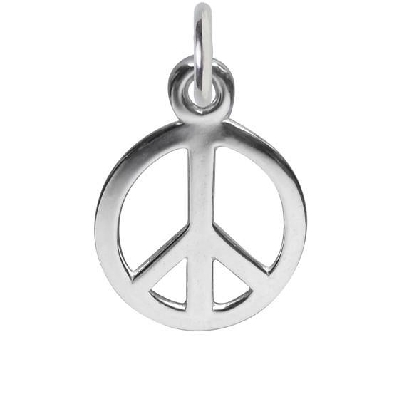 Silver peace symbol charm on white background