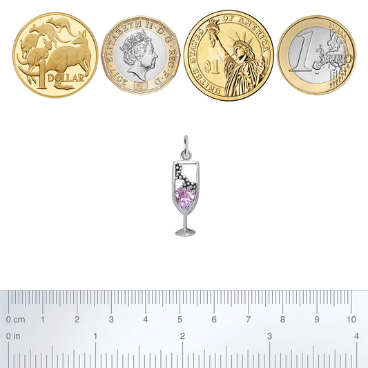 silver pink champagne glass charm with coins and ruler for scale