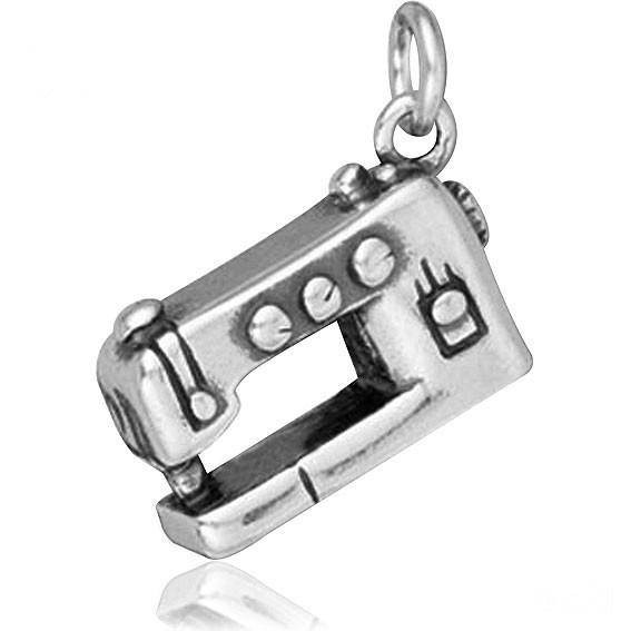 Modern style silver sewing machine charm on a white background