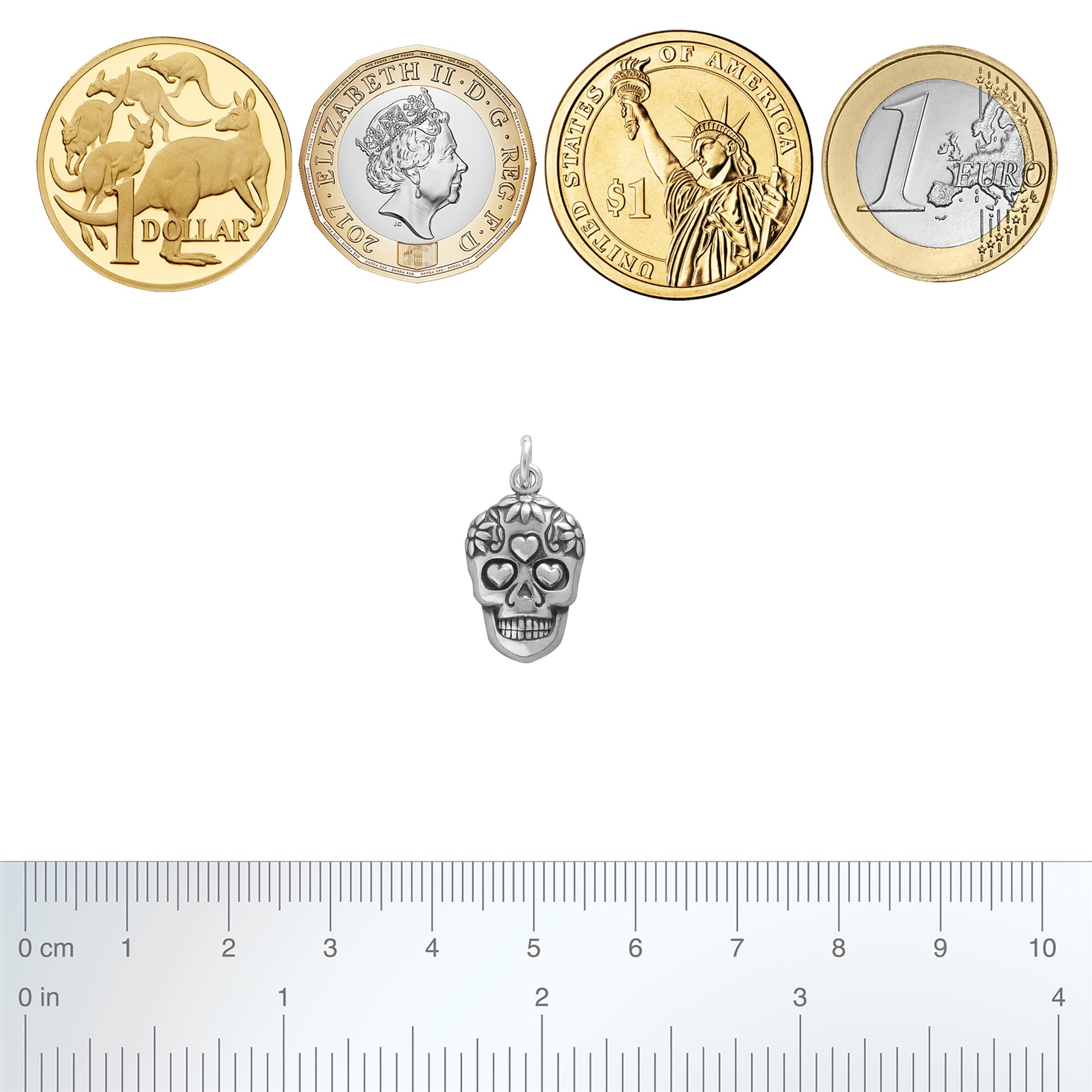 silver sugar skull charm with coins and ruler for scale