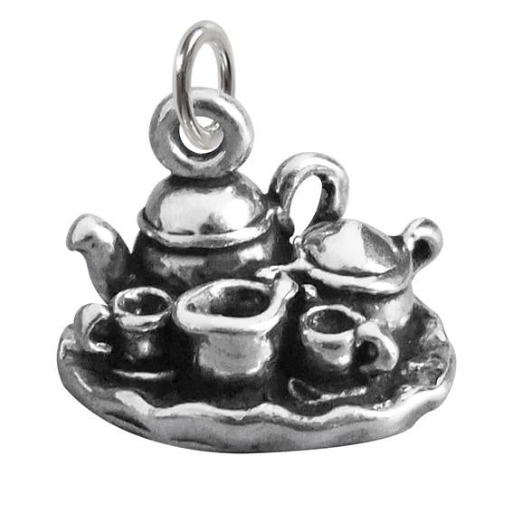 silver tea set charm on white background